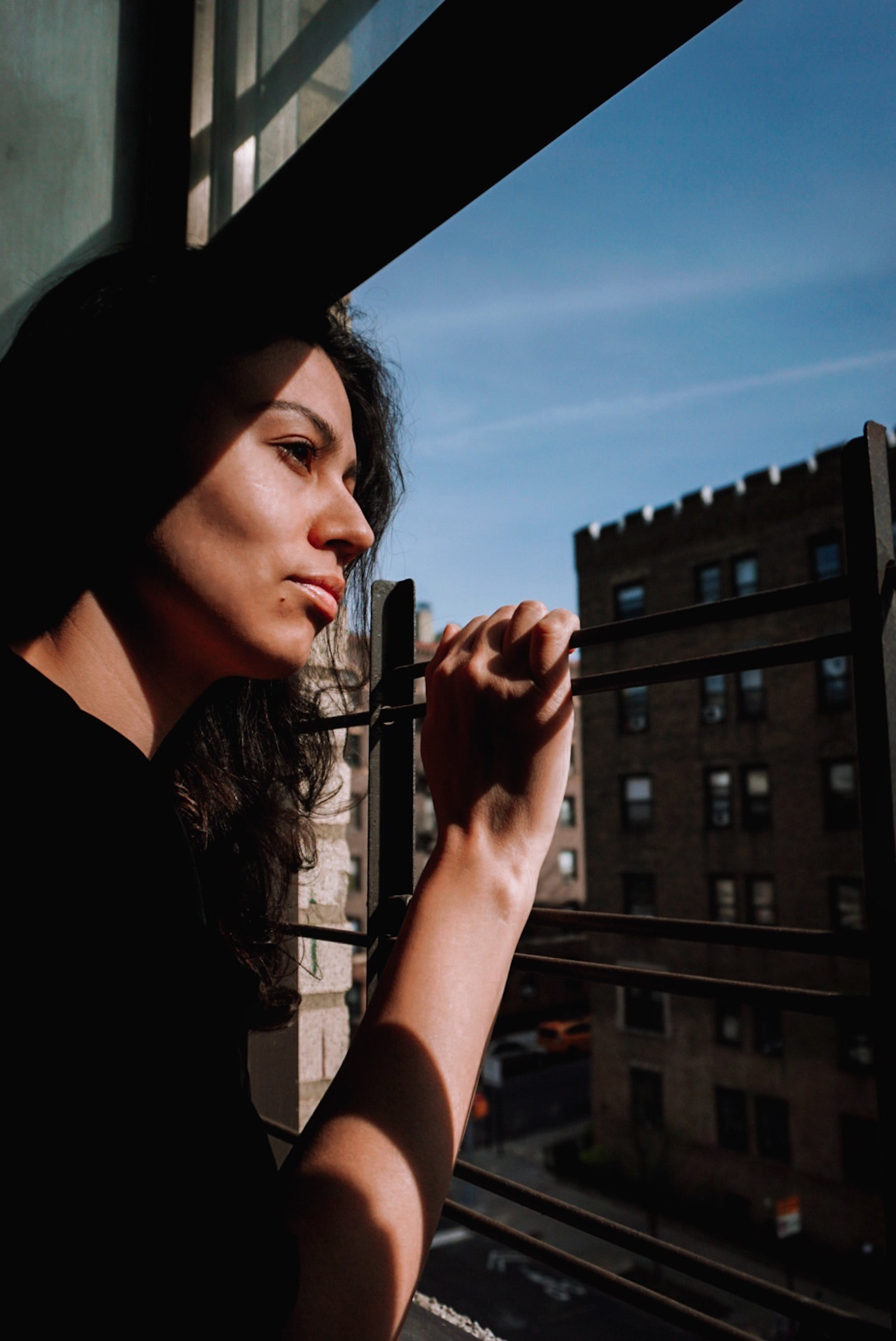 nyc girl looking out from window during covid19